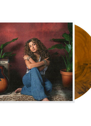 the album cover for Tori Kelly - God Must Really Love Me [Translucent Orange with Black Swirls]