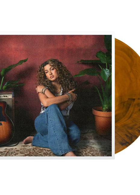 the album cover for Tori Kelly - God Must Really Love Me [Translucent Orange with Black Swirls]