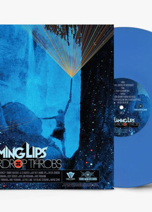 the album cover for The Flaming Lips - The Teardrop Throbs [Indie Exclusive Opaque Blue]
