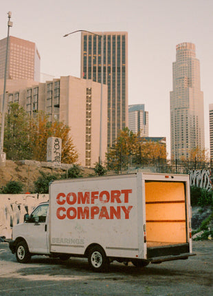 the album cover for Bearings - Comfort Company [Indie Exclusive Half Baby Pink / Half Red w/ white splatter LP]
