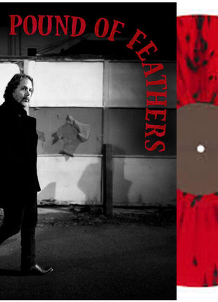 the album cover for The Black Crowes - A Pound Of Feathers [Indie Exclusive Red with Black Spatter]
