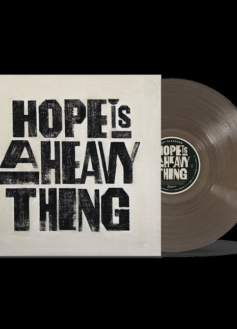 the album cover for Joy Oladokun - Hope Is A Heavy Thing [Transparent Black Ice]